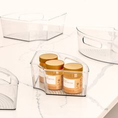 three containers with lids on a counter top