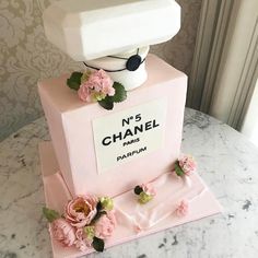 a pink chanel cake with flowers on top