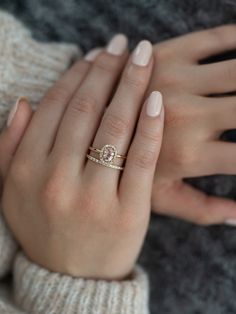 a woman's hand with a ring on it and two hands holding the other