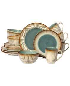 a set of dishes with cups and saucers