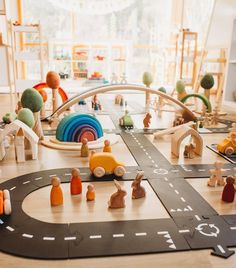 a child's play area with wooden toys on the floor