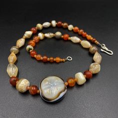 The beautiful mala necklace consist of Himalayan luk Mik or we called them magic eye bead as well in the center of the mala necklace with Banded Agate and carnelian Luk Mik means (Goat's eyes) in Tibetan Natural found from Himalaya Tibet dating more than 1000 yrs. The origin of this beads from Himalaya Tibet but also can found in India, Nepal and Pakistan too They were used as a special charm Jewelry and amulet at that time period very good condition They were used in prayers mala and used as am Spiritual Round Chalcedony Bead Jewelry, Round Agate Gemstones For Spiritual Use, Spiritual Round Agate Beaded Gemstones, Spiritual Agate Round Bead Gemstones, Spiritual Round Agate Bead Gemstones, Amber Single Strand Spiritual Necklace, Spiritual Chalcedony Gemstone Beads Necklace, Bohemian Single Strand Agate Necklace, Spiritual Round Beads Single Strand Gemstones