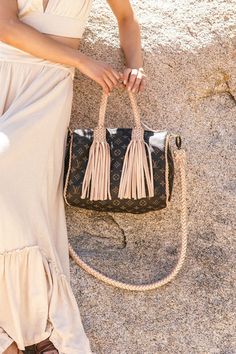 This iconic bag has an unmistakable shape and unites timeless design with our heritage details while being lightweight and very roomy. Tailor-made and hand-braided natural cowhide trim and rolled comfortable handles slip easily over the arm, with a detachable shoulder or cross body strap for the epitome of a classic made Boho-chic and more comfortable. Dimensions: Width: 11.8" Depth: 7” Strap Length: 47" Strap Type: Wide Round Braided, Interchangeable Handle Type: Round Braided Guarantee Of Auth Luxury Handheld Satchel With Braided Handles, Luxury Shoulder Bag With Braided Handles, Luxury Satchel With Braided Double Handles, Luxury Straw Satchel With Braided Handles, Luxury Everyday Straw Bag With Handles, Beige Leather Straw Bag With Braided Handles, Luxury Satchel With Braided Handles, Leather Satchel Bag Strap With Leather Handles, Luxury Satchel Bag With Braided Handles