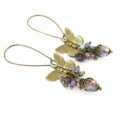 These vintage-inspired earrings are fashioned from beautifully detailed antiqued brass and Czech glass beads. The beads are in shades of purple and lilac, with the largest beads and the flower beads having a subtle bronze sheen which gives them some extra sparkle when viewed from different angles. I dangled the drops on extra long dainty ear wires to give them a whimsical feel. (If you would like different ear wires, please let me know as I would be happy to make you a custom pair.)------------- Brass Wedding, Vintage Inspired Earrings, Long Flowers, Whimsical Jewelry, Flower Cluster, Earrings Purple, Butterfly Earrings, Shades Of Purple, Czech Glass Beads