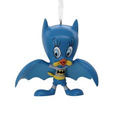 an ornament shaped like a blue bird with a bat on it's chest