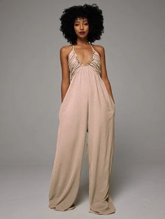 Halter Wide-Leg Jumpsuit Spring Backless Jumpsuits And Rompers For Loungewear, Backless Solid Color Jumpsuits And Rompers For Spring, Fitted Halter Neck Jumpsuit For Loungewear, Spring Backless Solid Color Jumpsuit/romper, Spring Solid Color Backless Jumpsuits And Rompers, Stretch Jumpsuits And Rompers For Summer Day Out, Summer Stretch Jumpsuits And Rompers For Day Out, Spring Halter Neck Jumpsuit, Spring Halter Neck Jumpsuit Or Romper