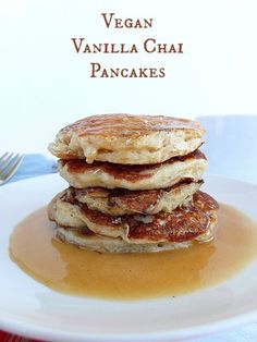 a stack of pancakes sitting on top of a white plate covered in syrup next to a fork