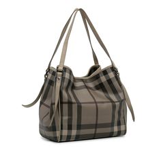 Product Details: Brown Burberry Smoked Check Canterbury Tote. The Canterbury Tote features a coated canvas body, flat leather shoulder straps, an open top with magnetic closure, and a zip pouch inclusion. 10.6" L x 10.4" W x 6.1" D, 8.7" drop. Serial number CNSANQITDON. Condition: . Very Good. Exterior Front stained with Transfer Of Color. Exterior Back stained with Transfer Of Color. Exterior Bottom stained with Transfer Of Color. Exterior Handle Discolored, Out Of Shape. Exterior Handle staine Color Interior, North Korean, Out Of Shape, Canterbury, Zip Pouch, Open Top, Magnetic Closure, Brunei, Shoulder Straps