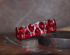 "Beautiful bracelet with red rhinestone crystals, great statement piece! Pageant, prom, or bridal! Size: .75\" wide Style: stretch bracelet color: red crystals / silver base metal red/ gold base metal Looking for matching earrings or necklace? Browse through our listings or send us a message! :) https://www.etsy.com/listing/507893090/red-rhinestone-earrings-large-crystal?ref=shop_home_active_3 https://www.etsy.com/listing/551764936/red-rhinestone-necklace-and-earrings-set?ref=shop_home_active_15 Prom Bracelet, Red Rhinestone Earrings, Red Bracelet, Red Prom, Large Crystal, Red Bracelets, Earrings Large, Red Rhinestone, Rhinestone Bracelet