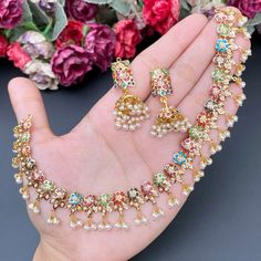 Featuring an evergreen navratna jadau necklace with jhumkis made in 22ct gold.  The necklace weighs 25.35 GMs including 3.37 GMs of hanging pearls.  The jhumkis weigh 14.28 GMs including 1.82 GMs of hanging pearls. Price Breakup Summary Component Rupees % of Total 22k Gold 147,928 74.5% Stones & Beads 18,243 9.2% M Navratna Jewellery, 22k Gold Jewelry Necklaces, Jadau Necklace, Jadau Jewellery, 22k Gold Jewelry, Pearl Necklace Set, Gold Jewelry Necklace, Jewellery Gold, Jewelry Design Earrings