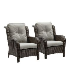 two brown wicker chairs sitting next to each other on top of a white background