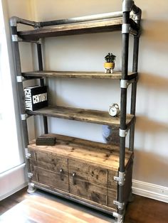 a wooden shelf with metal pipes and drawers