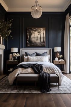 a bedroom with dark blue walls and white bedding, an art work on the wall