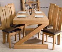 a wooden table with four chairs around it