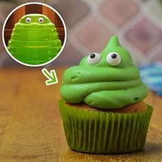 a cupcake with green frosting and googly eyes