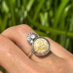 A beautiful round fossilized coral ring with intricate little starburst, accented with a sterling silver starburst with a tiny little moonstone in the center. Simple and sweet with a little piece of the oceans mystery! This ring is unfinished so that it can be finished in your size. **Please note that this is to be finished in your size upon purchase so please allow 7-10 days processing time before shipment.** All of my work is hand crafted, from sourcing the stones from sustainable miners and l Nature-inspired Round Moonstone Ring In Sterling Silver, Nickel-free Nature-inspired Round Rings, Nature-inspired Nickel Free Round Rings, Nature-inspired Nickel-free Rings, Nature-inspired Nickel Free Rings, Nature-inspired Round Cabochon Jewelry, Unique Nickel-free Moonstone Ring, Nature-inspired Sterling Silver Cabochon Ring, Soft Jewelry