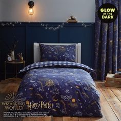 a bed room with a blue comforter and pillows