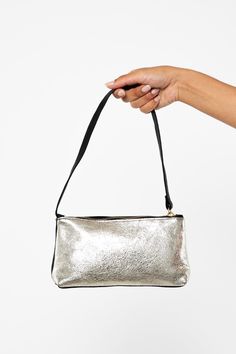 The Embellished Zip Pochette is a pouch shoulder bag with a zipper closure. This artisanal product is made of genuine leather. All scars are characteristics of the skin and not imperfections. We hope you enjoy this unique handmade object.- Brass zipper- Genuine Cowhide- Handmade in the U.S.A. | Embellished Leather Zip Pochette in Silver/Black Silver Leather Clutch Shoulder Bag, Leather Clutch Evening Bag With Zipper, Leather Shoulder Bag For Party, Leather Pouch With Zipper Closure, Leather Shoulder Evening Bag With Zipper, Silver Leather Evening Bag For Everyday Use, Gold Soft Leather Shoulder Bag For Party, Silver Leather Evening Bag, Gold Leather Handheld Evening Bag