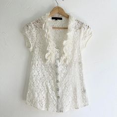 Y2K White Crochet Lace Semi Sheer Fitted Blouse Shirt  Button closure with short capped sleeves. Great condition  Brand - Heart Soul Tag size - XS Seen on size Small Measurements (laying flat) Chest - 15.5 in Length - 22 in #fairygrunge #whimsygoth #whiteblouse #cottagecore #babydollshirt Casual Lace Blouse With Short Sleeves, Casual Lace Top With Short Sleeves, Casual Lace Tops With Button Closure, Casual Lace Top With Button Closure, Spring Lace Top With Short Sleeves, Lace Button-up Top, Fitted Lace Button-up Top, Lace Button-up Tops With Button Closure, Lace Tops With Button Closure