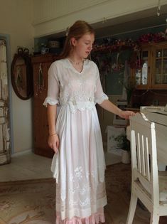 A beautiful gauze cotton tea dress from the 1910s. You see the floral embroidery work and hand made scalloped edges. The color is off white. The top part has an inner tulle lace blouse. This one has some stretch: Bust 88 cm up to 92 cm   34.5 inches up to  36 inches. The waist of the dress is 70 cm  27.5 inches, and the length 137 cm  54 inches. The skirt has two layers of transparent gauze cotton.  My model is wearing a pink silk slip dress under neath. This one is not included with the dress. Edwardian Tea Dress, Lawn Dress, Silk Slip Dress, Silk Slip, Scalloped Edges, Tulle Lace, Pink Silk, Tea Dress, Lace Blouse