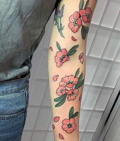 a woman with a flower tattoo on her arm