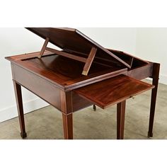 a wooden desk with a drawer on the top and an open drawer at the bottom