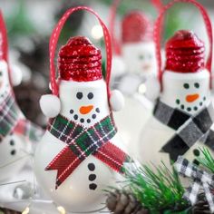 christmas ornaments with snowmen on them and pine cones