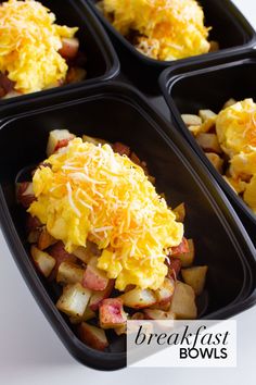 four black trays filled with breakfast foods on top of a white tablecloth and text overlay reads breakfast bowls