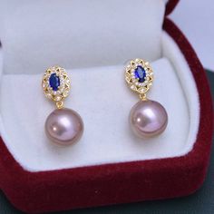 Make a lasting impression with the 11-12mm Freshwater Pearl & Blue Gem Cubic Zirconia Earrings-. These gorgeous earrings are set in a vintage-inspired silver alloy setting and feature shimmering white freshwater pearls and blue Cubic Zircoina gems. The combination of these two elements will bring a touch of elegance to any look, making them perfect for any occasion. Showcase your style and sophistication with this timeless piece from House of Pearls. This popular earrings design features AAAA qu Blue Pearl Earrings For Formal Occasions, Blue Pearl Earrings For Formal Events, Blue Pearl Earrings Fine Jewelry For Formal Events, Luxury Blue Pearl Earrings For Anniversary, Elegant Blue Pearl Earrings For Anniversary, Blue Round Pearl Earrings For Anniversary, Classic Blue Pearl Drop Earrings, Elegant Blue Pearl Drop Earrings, Classic Blue Round Pearl Earrings