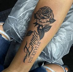 a woman's arm with a rose and the words mommy mary tattooed on it