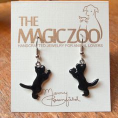 "These enamel black cat earrings make a fantastic gift for the cat lover! Do you happen to think black cats bring good luck! I do, and why not? These handcrafted and hand painted earrings are each 1\" tall by 3/8\" wide and come on stainless steel ear wires. By the way, they would be wonderful to wear on Halloween! When I create a pair of enamel earrings, they are usually created mirror-image style, with the right and left earring facing each other. Because of the hand crafted nature of my work, Black Cat Ears Jewelry For Gifts, Black Cat Ears Jewelry As A Gift, Black Novelty Jewelry For Gifts, Black Cat Ears Jewelry With Cat Design, Novelty Black Cat Design Jewelry, Black Cat Design Novelty Jewelry, Novelty Black Jewelry With Cat Design, Black Novelty Jewelry With Cat Design, Black Enamel Nickel-free Earrings