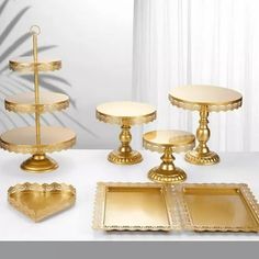 three tiered cake stand with two trays and one serving platter on the table