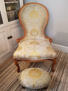 an old chair and ottoman in a room