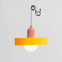 an orange and yellow light hanging from a ceiling fixture with a cord attached to it