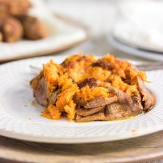 a close up of a plate of food on a table with other plates in the background