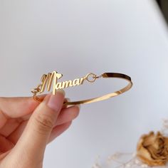 This bangle is handmade according to your names and size,High-quality gold plating, lasting color retention,3 mm width is very dainty,If you order this for baby,we could make it according to the size the baby need,just note the size please. Material： stainless steel, high-quality 18 K gold Plated(High quality Color retention) Size: Bangle width: 3 mm, Name plate size: about 8 mm*35 mm(Adjust according to name length) Custom: 1, Select the color and size you need. 2, Input the name and font you w Engraved Name Bangle Bracelet For Mother's Day, Customizable Gold Bangle For Anniversary, Custom Name Gold Bangle, Elegant Gold Bangle With Custom Name, Mother's Day Engraved Name Bangle Bracelet, Gold Name Bracelet As Gift For Mom, Gold Customizable Name Bracelet As Gift For Mom, Custom Name Bangle For Mother's Day, Customized Gold Bracelets For Mother's Day