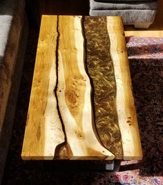 two pieces of wood sitting on top of a wooden table next to a couch in a living room