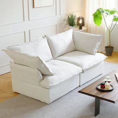 a living room with a white couch and coffee table