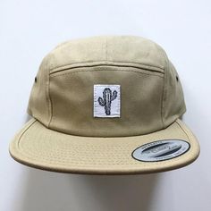 The "Cactus" 5 Panel Camp Hat Is Made In A Low Profile, Classic Fit With An Adjustable Clip Closure. 100% Cotton With Woven Label Sown On By Our Own Hands In The Usa. One Size Fits All, Unisex Fit. Imported. Summer Khaki Snapback Hat, Casual Khaki Snapback Hat With Flat Brim, Adjustable Khaki Baseball Cap With Short Brim, Khaki Flat Bill Hat One Size Fits Most, Adjustable Flat Bill Hat In Khaki, Khaki Flat Brim Hat One Size Fits Most, Adjustable Casual 5-panel Hat, Adjustable Khaki Flat Bill Hat, Khaki Flat Bill Hat, One Size Fits Most