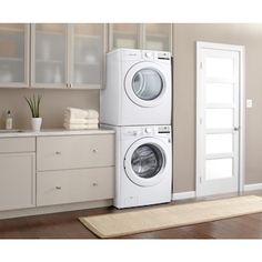 a washer and dryer sitting next to each other in front of a door