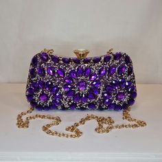 Womens purple crystal encrusted luxury evening clutch bag with gold embellishment, metallic satin finish material and crystal diamond detailed top closing clasp Can be used with or without long shoulder chain (included) size approx- H 10cm x W 20cm Free Royal Mail delivery is an estimated 3-5 days but this can occasionally be slightly longer which solely on the Royal Mail side. We do offer guaranteed next day delivery but please contact us prior to ordering as this would incur a small upgraded shipping charge. We also offer WORLDWIDE shipping - please contact us for more info 💕🌍 Elegant Purple Evening Bag For Formal Occasions, Luxury Purple Clutch For Evening, Elegant Purple Clutch For Event, Elegant Purple Clutch For Events, Gold Crystal Evening Bag For Prom, Gold Crystal Bags For Prom, Luxury Purple Rectangular Evening Bag, Elegant Purple Rectangular Evening Bag, Elegant Purple Party Bag