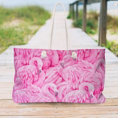 "Our oversized Weekender Pink Flamingo Tote is perfect for your weekend at the beach or in town. The wide-mouthed, durable bag holds a generous amount of personal items and is easily held by its thick rope handles. Stylish gift idea. .: 100% Spun Polyester .: T-bottom .: Cream sheeting interior lining .: One size: 24\" x13\" (60.9 cm x 33 cm) .: Handle height, in 11.42, cm 29.00 .: NB! Size tolerance 0.75\" (1.9 cm)) Care instructions: Before cleaning the bag, remove all the items from the bag. Pink Canvas Bag For Beach Travel, Beachy Weekend Tote Bag, Summer Shoulder Bag With Large Capacity For Weekend, Large Capacity Summer Shoulder Bag For Weekend, Large Capacity Beach Bag For Summer Weekend, Large Capacity Bags For Weekend Beach Season, Large Capacity Beach Bag For Weekend Vacation, Summer Weekend Shoulder Beach Bag, Summer Beach Bag For Weekend, Rectangular Shape