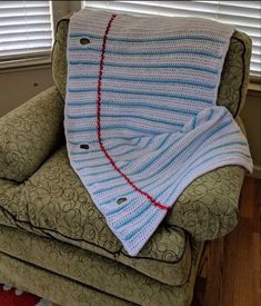 a crocheted blanket sitting on top of a chair