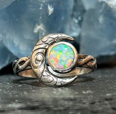 Crescent moon opal ring in solid sterling silver with a Celtic knot band. This ring is made to order in your size. The stone measures 6mm in size and the moon in 12mm. These are man made opals and they are absolutely stunning. Custom orders are welcome. Feel free to contact me with questions or comments.  Ring size. Made to order in your size. Celtic Knot Band, Celtic Knot Jewelry, Crescent Moon Jewelry, Knot Jewelry, Opal Band, Jewelry Knots, Blue Moonstone, Moon Jewelry, Opal Ring