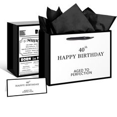 a black and white birthday card in a gift bag