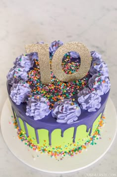 a birthday cake with sprinkles and the number ten on it's top