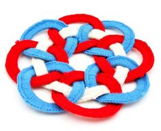 four red, white and blue pieces of fabric in the shape of an interlocked knot