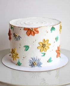 a white cake with colorful flowers on it