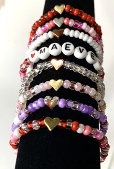 Stacking boho valentine bracelets. You chose the beads, personalization, and heart bead color. These adorable and trendy stacking seed beads bracelets make great gifts. Heart beads are metal and come in silver, gold, or rose color colors. This listing is for ONE bracelet. Pictures are examples. Your choices Style: Plain - Seed beads only With Heart - Seed beads and your choice of heart bead With Name - Seed beads with personalization and red heart beads surrounding the name. Seed bead colors: Al Trendy Valentine's Day Bracelet Jewelry, Trendy Letter Beads Jewelry For Friendship, Pink Dainty Jewelry For Personalized Gifts, Dainty Pink Jewelry For Personalized Gift, Personalized Pink Dainty Beaded Bracelets, Cute Heart Bracelet With Round Beads For Valentine's Day, Heart Shaped Letter Beads Jewelry For Friendship, Handmade Heart Beaded Bracelet For Friendship, Beaded Heart Bracelet Gift