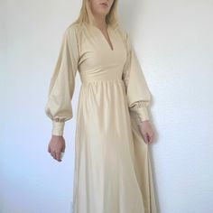 Soft Champagne-White Maxi Wedding Dress With Bishop Sleeves. Fits Size Small Or Extra Small Best. Measurements Laying Flat Are: 16" Pit To Pit 13.5" Waist 55" Length From Shoulder (Has About Another Inch In Seam Allowance) Has A Few Very Minor Flaws. The Button Was Repaired And Replaced At One Point, But It's Very Hard To Tell. The Zipper Also Acts A Little Odd When It's Unzipped, As Pictured Above. It Looks And Functions Great When Zipped Up. Wedding Dress With Bishop Sleeves, Dress With Bishop Sleeves, Maxi Wedding Dress, Handmade Wedding Dress, Wedding Dress Color, Handmade Wedding Dresses, Seam Allowance, Womens Vintage Dresses, Maxi Dress Wedding